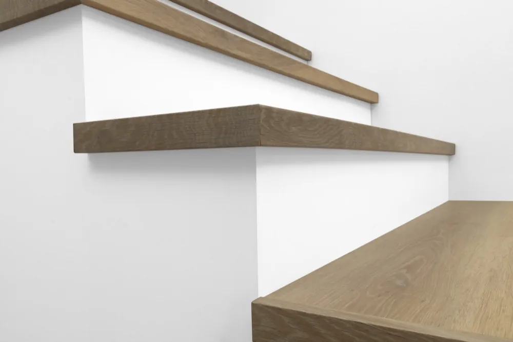 View from below of Urban Surfaces' All-In-One SPC Stair Treads installed on a staircase. Color is 2999 Yosemite from the Studio 12 FF product line.2999 Yosemite