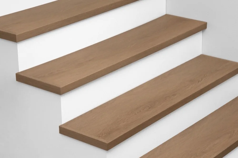 View from above of Urban Surfaces' All-In-One SPC Stair Treads installed on a staircase. Color is 9712 Mount Olympia from the T Molding product line.9712 Mount Olympia