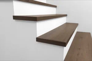 Side view of Urban Surfaces' All-In-One SPC Stair Treads installed on a staircase. Color is 2913 Hidden Acres from the Studio 12 SPC Vietnam product line.2913 Hidden Acres