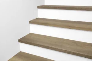 Wall view of Urban Surfaces' All-In-One SPC Stair Treads installed on a staircase. Color is 2999 Yosemite from the Studio 12 FF product line.2999 Yosemite