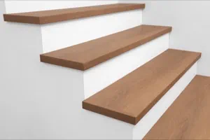 View of Urban Surfaces' All-In-One SPC Stair Treads installed on a staircase. Color is 9715 Pinnacle Grove from the T Molding product line.9715 Pinnacle Grove