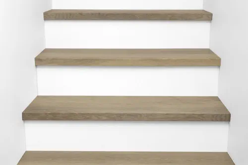 Front view of Urban Surfaces' All-In-One SPC Stair Treads installed on a staircase. Color is 2999 Yosemite from the Studio 12 SPC Vietnam product line.2999 Yosemite